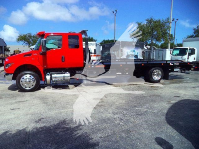 Red International MV rollback truck side view showing cab and flatbed with chrome fuel tanks and dual rear wheels.