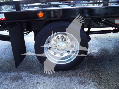 Wheel of a new International MV rollback truck with black frame and silver rim, partial rear area visible; stock watermark overlay not part of the component.