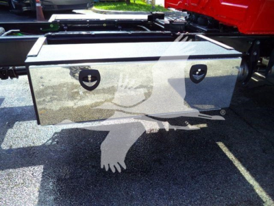 Storage box mounted under a rollback truck with metal exterior and two circular latches.