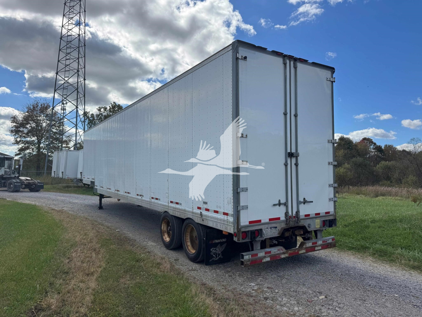 Manac 48' drop-side van trailer viewed from rear-right side, white, dual rear doors, standard rear bumper, dual wheels on each side, no visible branding on sides.