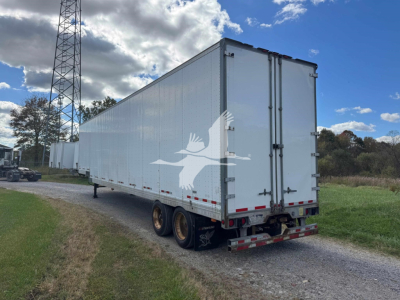 Manac 48' drop-side van trailer viewed from rear-right side, white, dual rear doors, standard rear bumper, dual wheels on each side, no visible branding on sides.