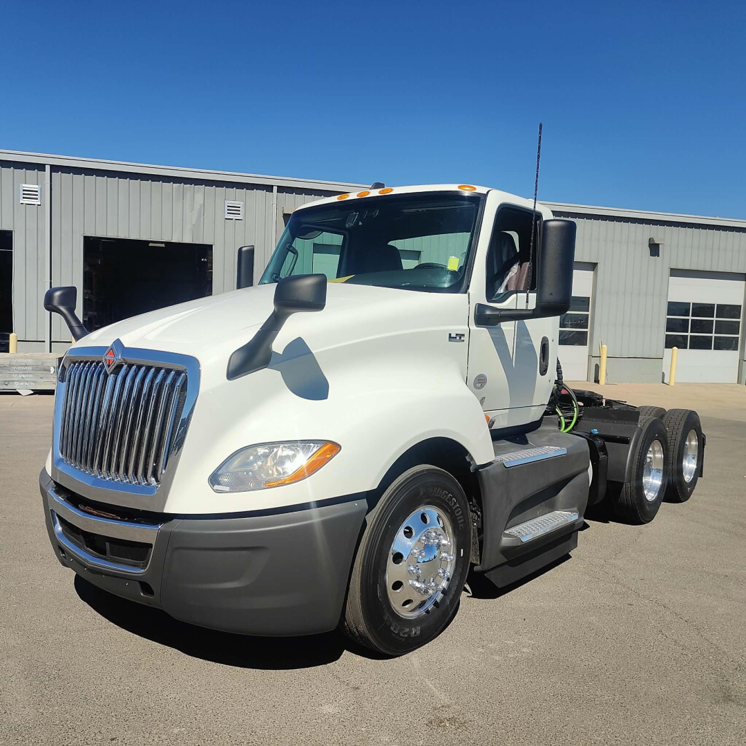International LT 2021 truck in white, front-left view showing cab, dual rear axles, and chrome wheels.