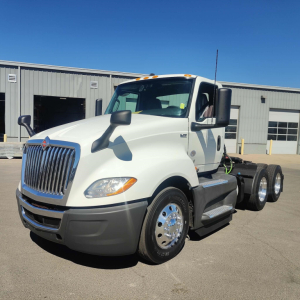 International LT 2021 truck in white, front-left view showing cab, dual rear axles, and chrome wheels.