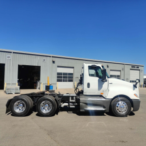 International LT conventional daycab truck side view showing chassis and rear axles with white cab