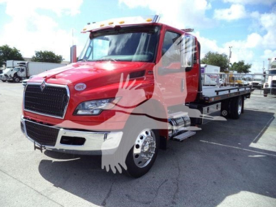 2027 International MV rollback truck with red cab and flatbed, front grille and headlights visible.