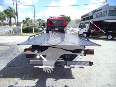 Tow truck flatbed/dolly bed showing rear view with tail lights and rear bumper, International MV 2027 stock image.