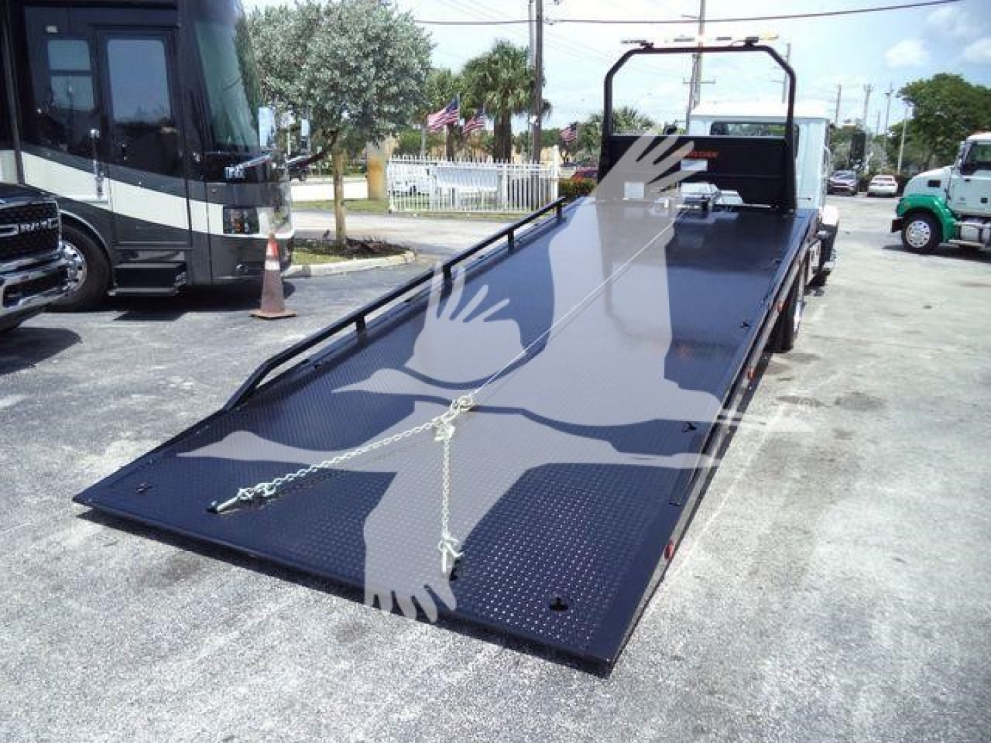 2025 Mack MD6 rollback truck bed showing aluminum surface with tie-down chains and ramp, stock J10538.
