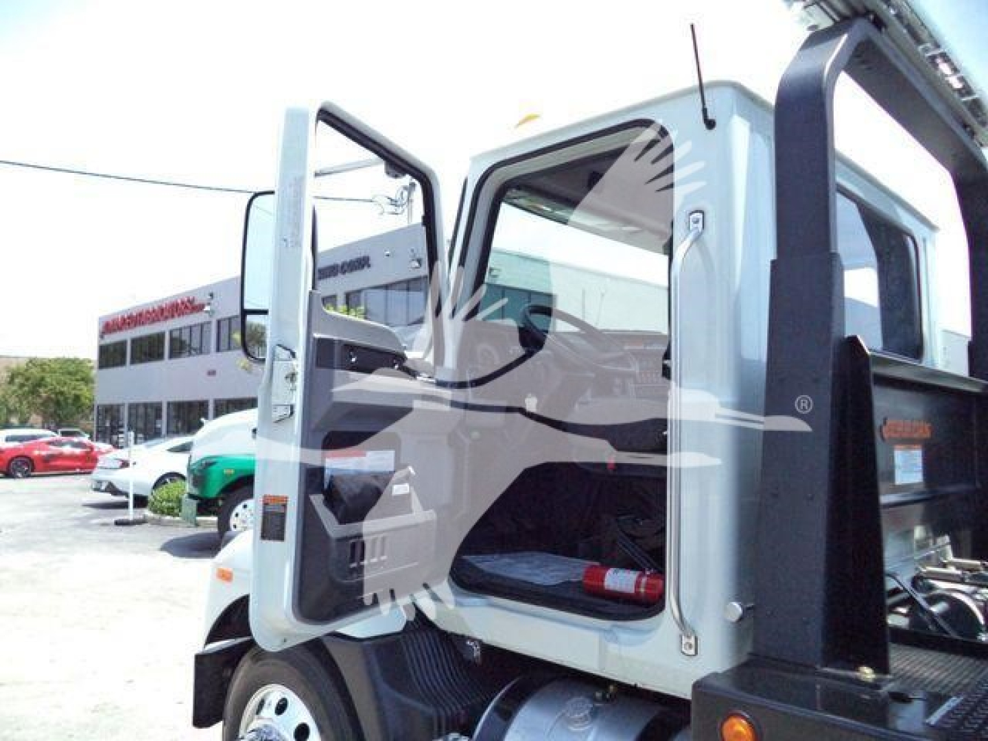 Mack MD6 truck cab interior view with door open showing seating and instrument panel
