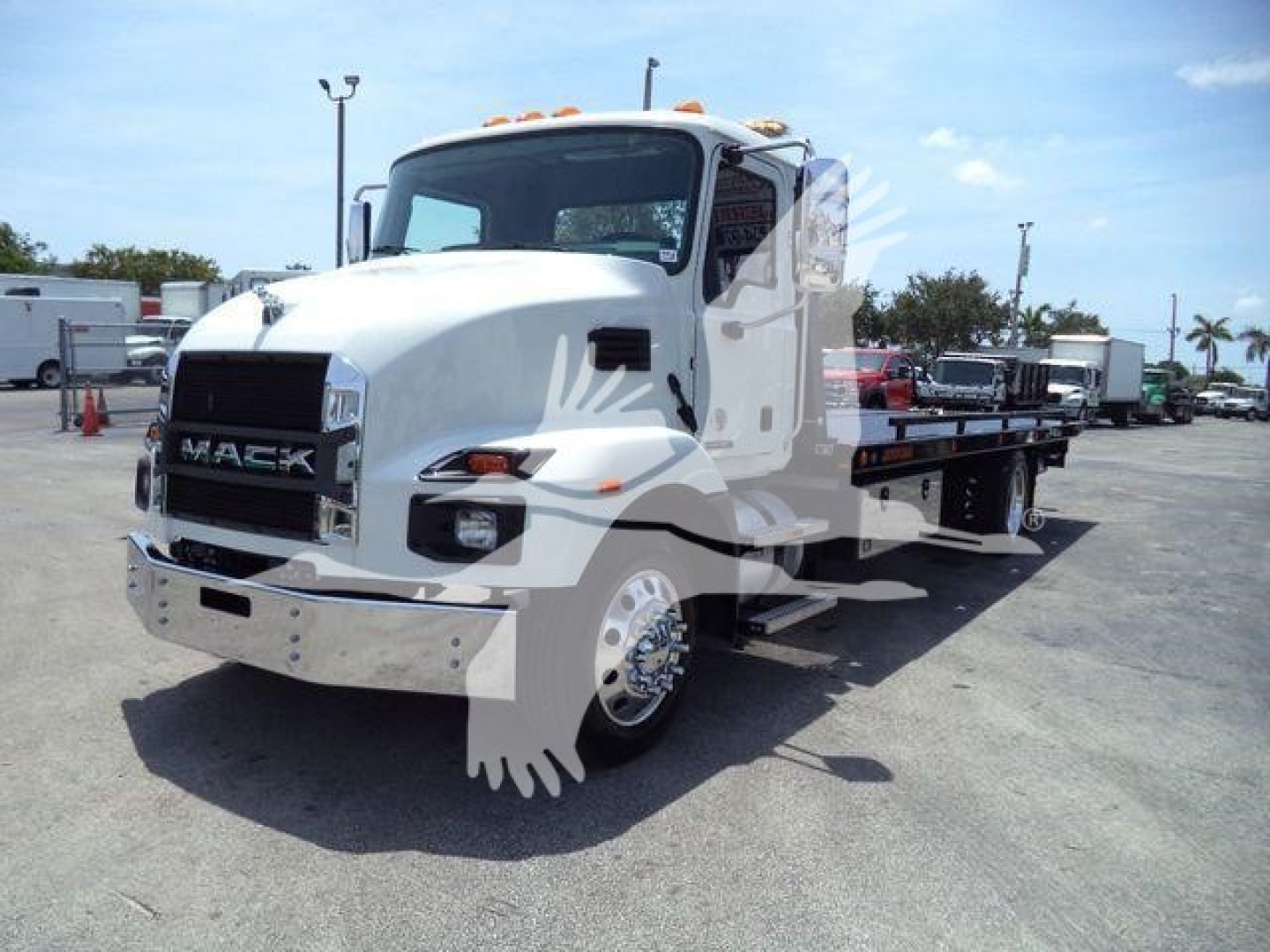Mack MD6 rollback truck in white, front-left view showing cab and flatbed; clear Mack emblem on grille.