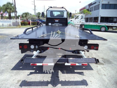 Truck flatbed tow truck rear view showing multi-LED taillights and metal platform with safety rails