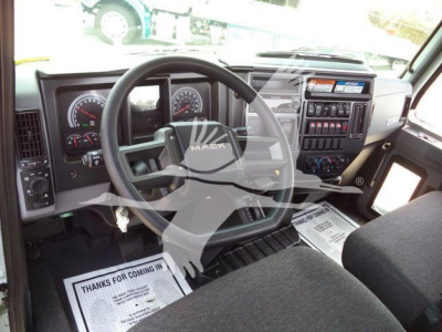 Mack MD6 truck interior showing steering wheel and dashboard with gauges and center console.
