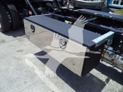 Rectangular metal toolbox mounted on a vehicle chassis, with two circular recessed handles and a textured black top surface.