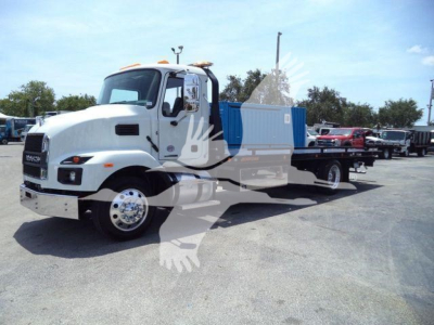 MD6 Mack rollback truck in service bay with dump bed and blue container, front angled view