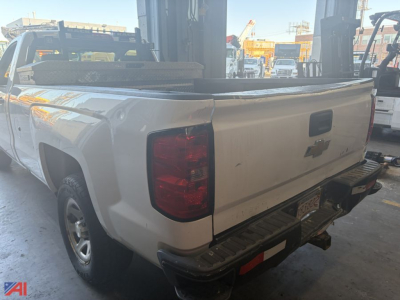 Pickup truck bed and rear quarter of a white 2016 Chevrolet Silverado 1500 2WD pickup, shown from rear-left side with tailgate and bumper.