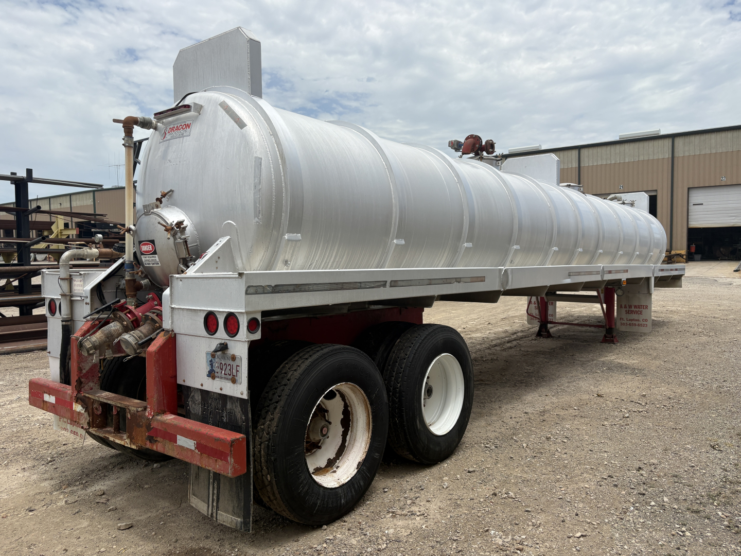 Tank trailer showing 150BBL vacuum unit with aluminum cylindrical tank and rear mud flaps.