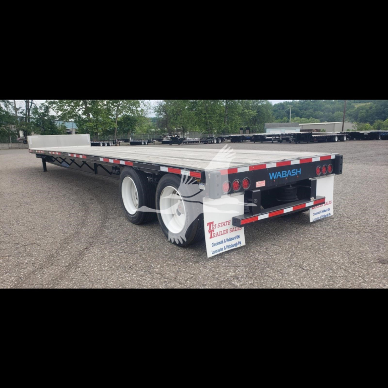 Wabash steel drop trailer with dual rear axles, showing brand name WABASH on tailgate, reflective striping, and mud flaps. Back shows lights, license plate area. Side is flatbed deck.