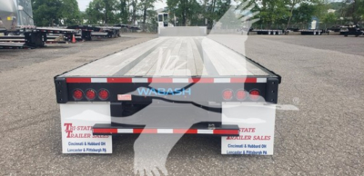 Wabash drop-closed tandem trailer rear view showing taillights, reflective tape, Wabash logo, bumper, and license plate area.