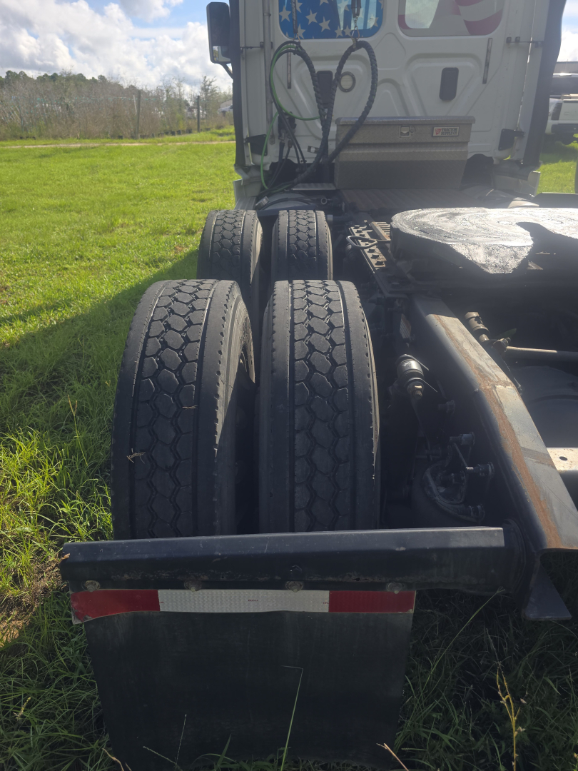 Freightliner Cascadia CA125DC day cab rear dual tires and chassis with mud flaps visible