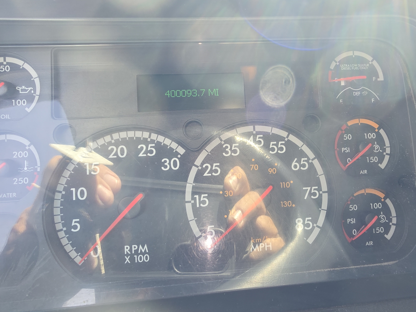 Dashboard of a Freightliner Cascadia showing speedometer and tachometer with digital display reading 400093.7 MI.