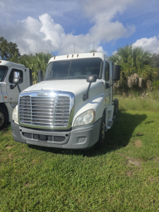 Truck front view of a white 2017 Freightliner Cascadia CA125DC day cab showing chrome grille, headlights, and front bumper.