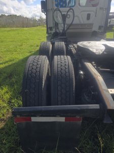 Freightliner Cascadia CA125DC day cab rear dual tires and chassis with mud flaps visible