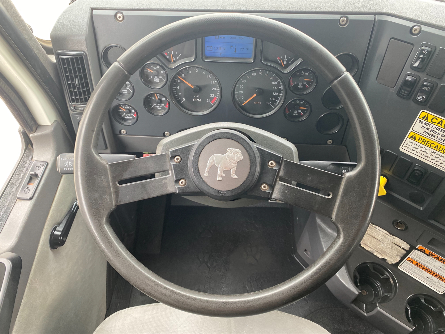 Dashboard of a 2018 Mack GU533 sleeper cab showing steering wheel with Mack bulldog emblem and gauge cluster including speedometer, tachometer, and digital display.