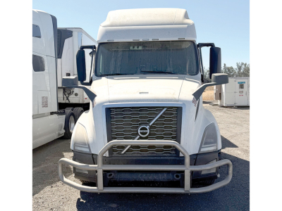 Volvo VNL 760 truck in a parking lot showing front view with grille, bumper guard, and side mirrors.