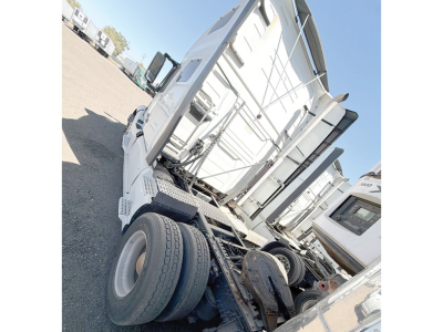 Volvo VNL 760 truck tractor cab rear view showing sleeper area and exposed drivetrain components.