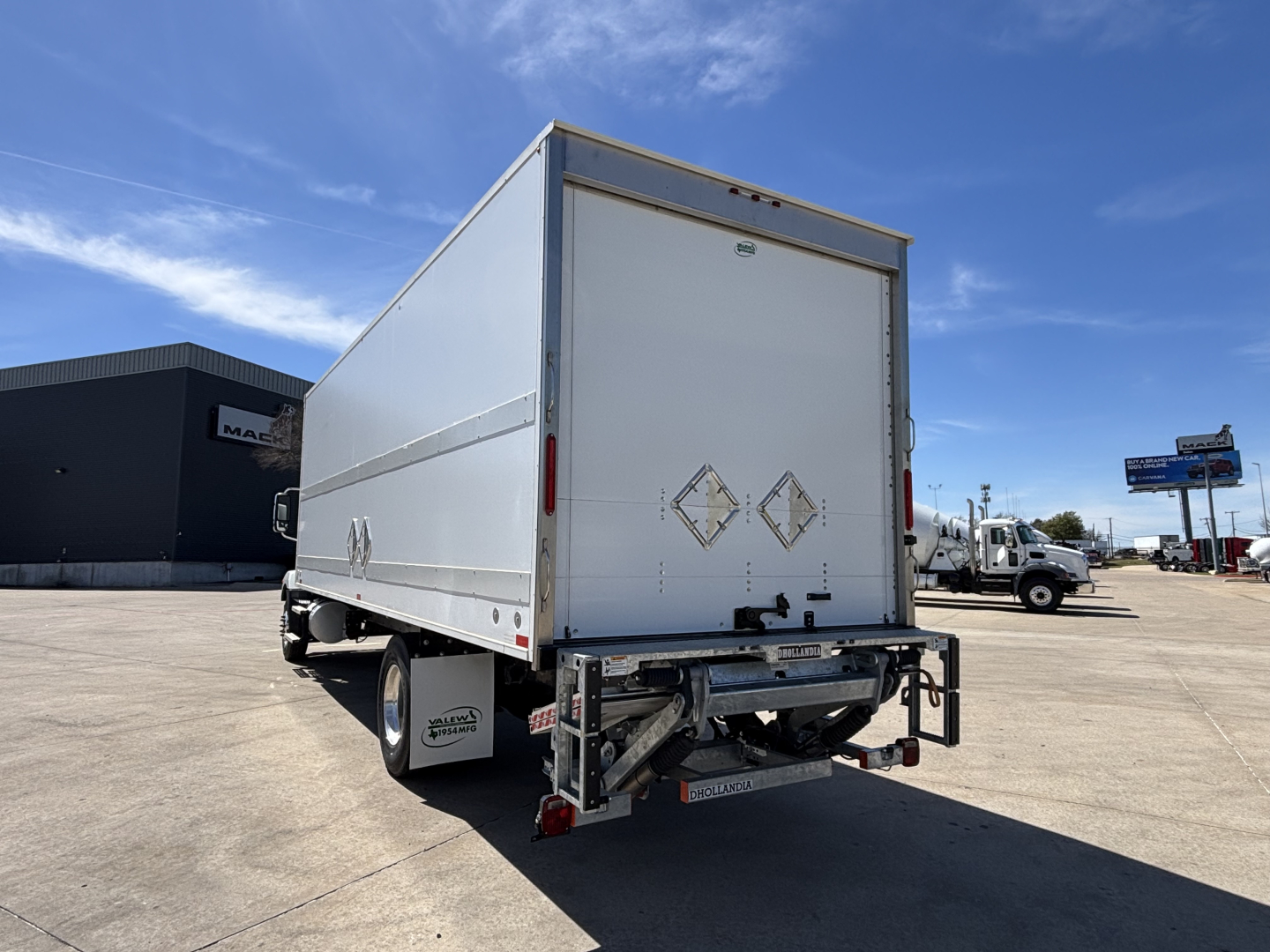 Box truck rear view showing cargo box and rear underride guard on a 2025 Mack MD7 trailer unit.