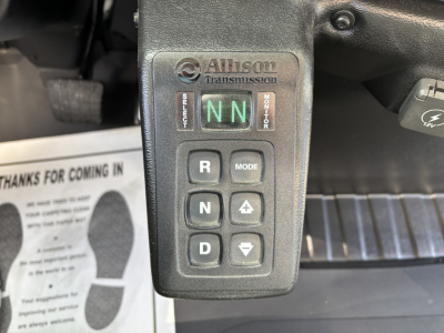 Allison transmission gear selector with green NN in display, labeled 'Allison transmission' and buttons R, N, D, MODE, up/down arrows, and brake pedal area visible.