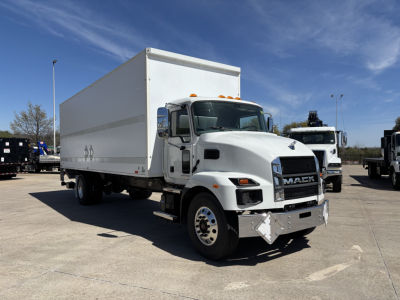 White Mack MD7 box truck in a lot, front grille with Mack logo, large cargo box, side mirrors, and orange clearance lights on cab roof.