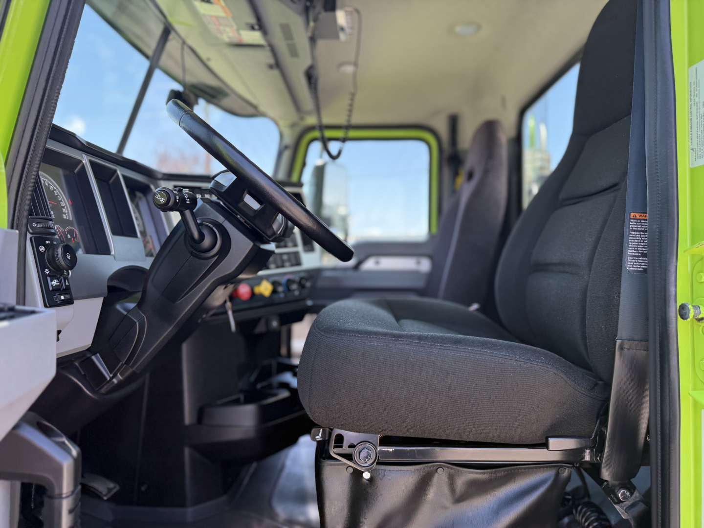 Mack AN64T truck cab interior showing driver seat and steering wheel, with dashboard and controls visible.