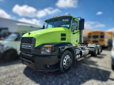 Mack AN64T conventional daycab showing bright green cab and black bumper with Mack grille.