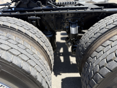 Mack AN64T truck axle area showing dual rear tires and suspension components.