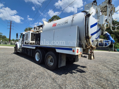 Freightliner M2 106V vacuum truck showcasing side tank and rear apparatus with Vaccon branding, three axles, white/blue color scheme.