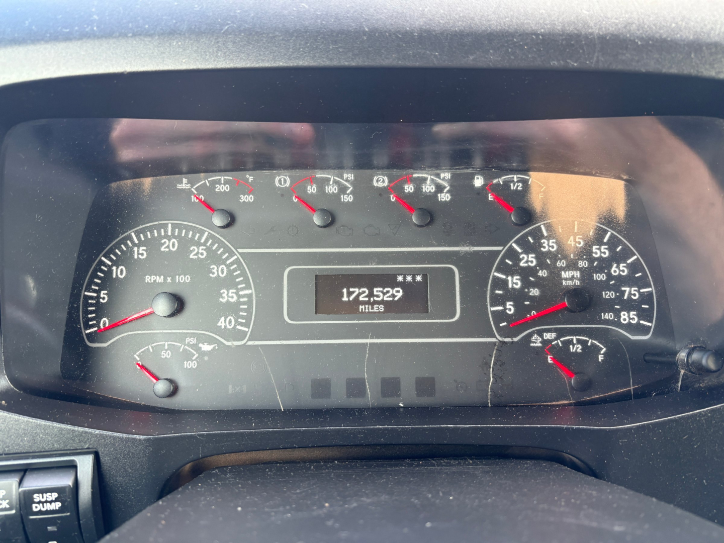 Truck dashboard showing instrument cluster with RPM gauge, speedometer, and mileage reading 172,529 miles. Various small gauges on top and right, with black face and white markings.