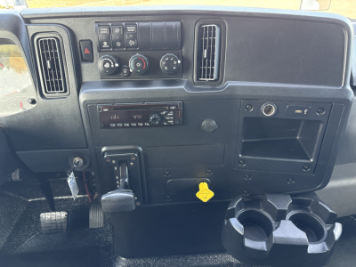 Dashboard of 2020 International MV607 truck showing center console controls, vents, radio, climate dials, cup holders, and auxiliary panels.