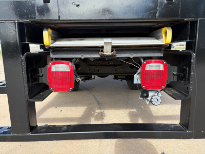 Rear view of a 2020 International MV607 truck showing taillights, bumper, and spare wheel carrier in a black chassis.