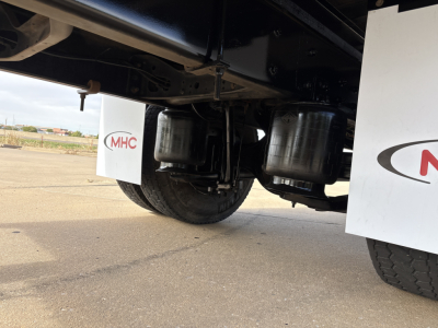 Underbody of a box truck showing dual air tanks and rear wheels; no legible model text visible.
