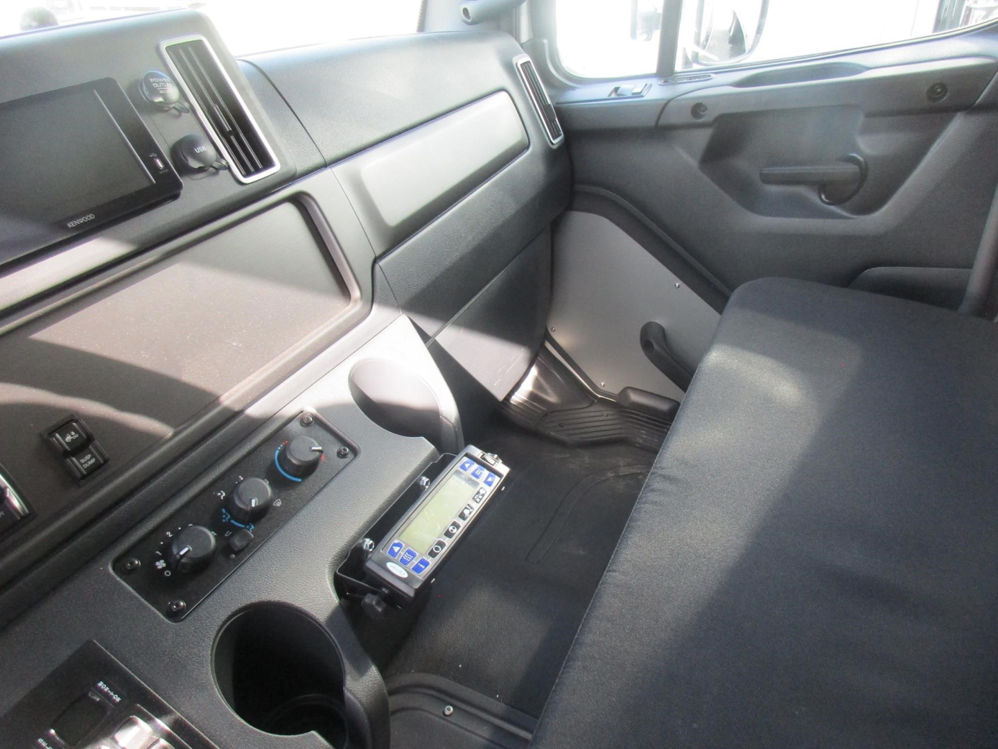 Cab interior of a 2026 Freightliner M2 106 Plus refrigerated truck showing dashboard, control panel, and passenger seat.
