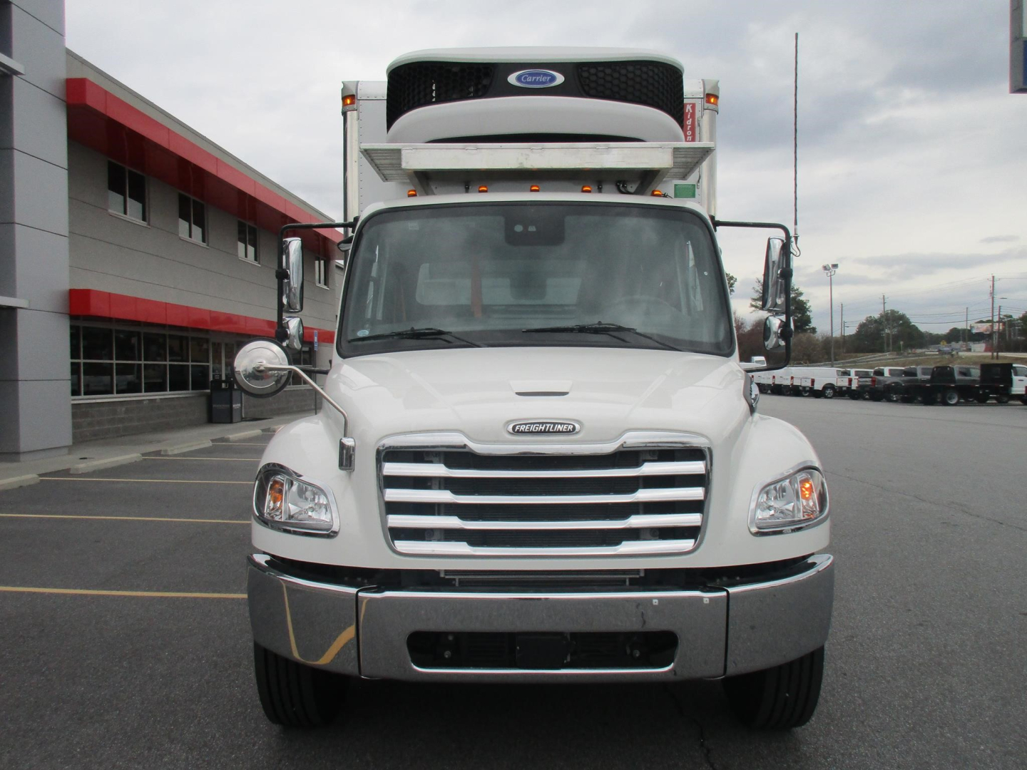 Front view of a white 2026 Freightliner M2 106 Plus refrigerated truck with a roof-mounted refrigeration unit and chrome grille; VIN tag and stock number not visible on image.