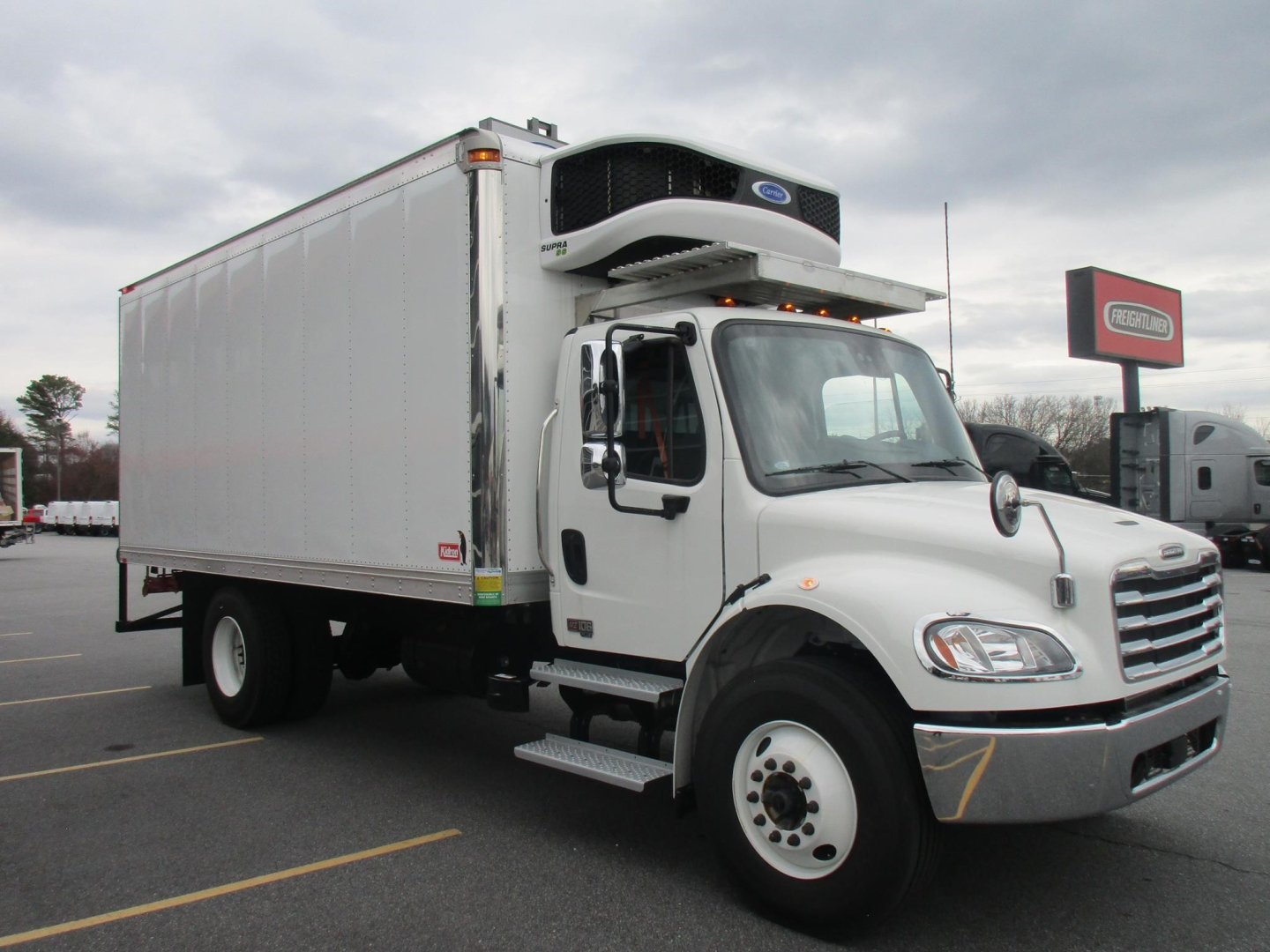 Freightliner M2 106 Plus refrigerated truck with a cargo box and front cab, VIN visible in listing info.