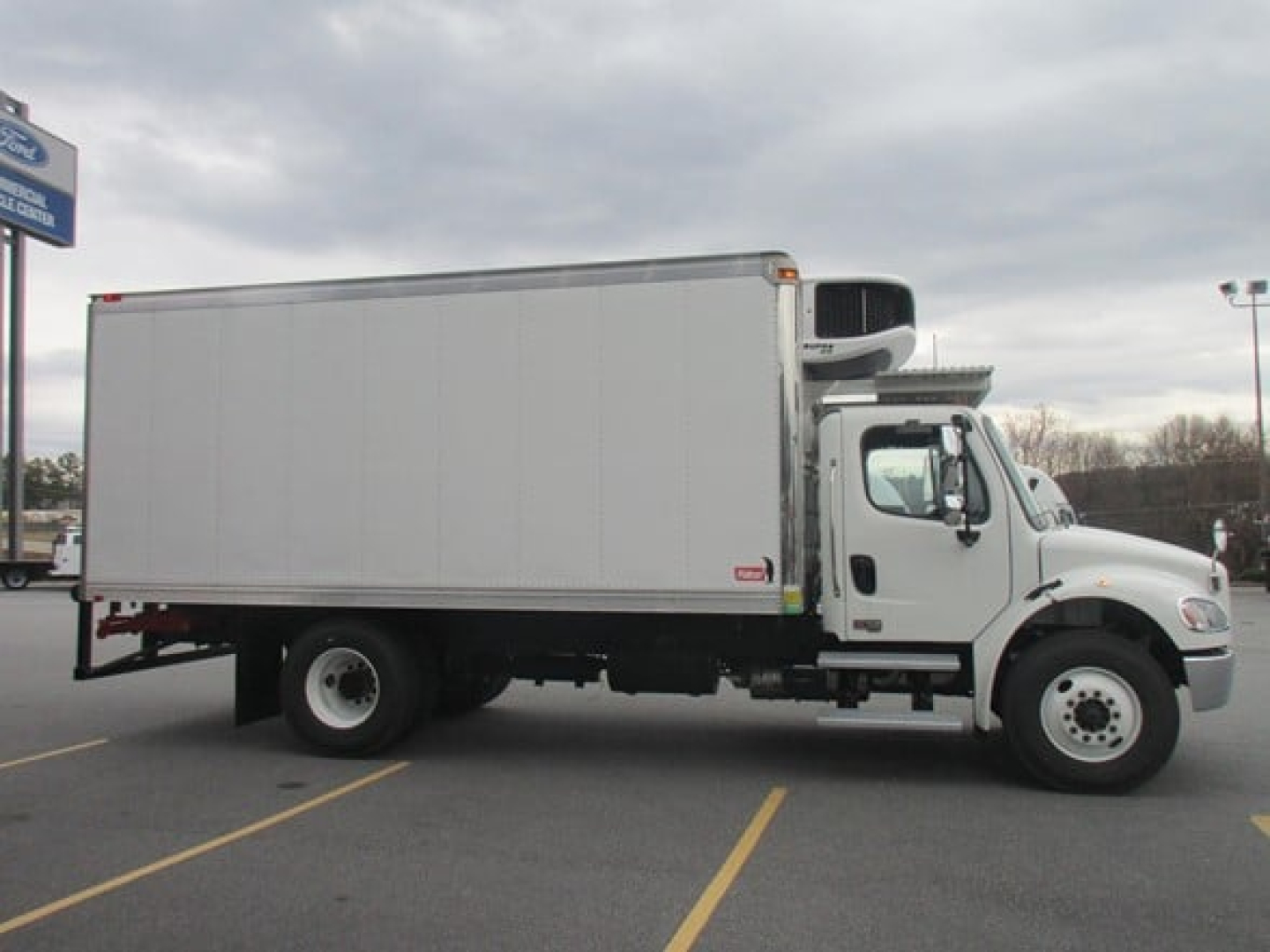 Freightliner M2 106 refrigerated truck side view showing box body and refrigeration unit