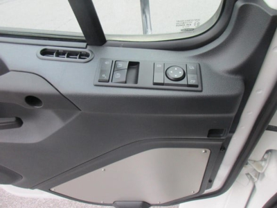 Cab interior door panel of a Freightliner M2 106 Plus showing window controls and door pocket panel.