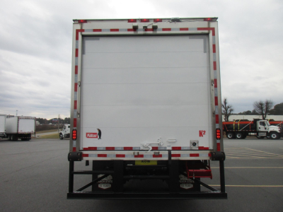 Freightliner M2 106 Plus rear view showing white box refrigerated body and bumper guard.