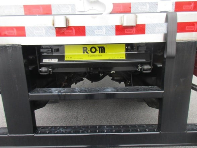 Refrigerated truck hitch area of a 2026 Freightliner M2 106 Plus showing ROM label on undercarriage component.