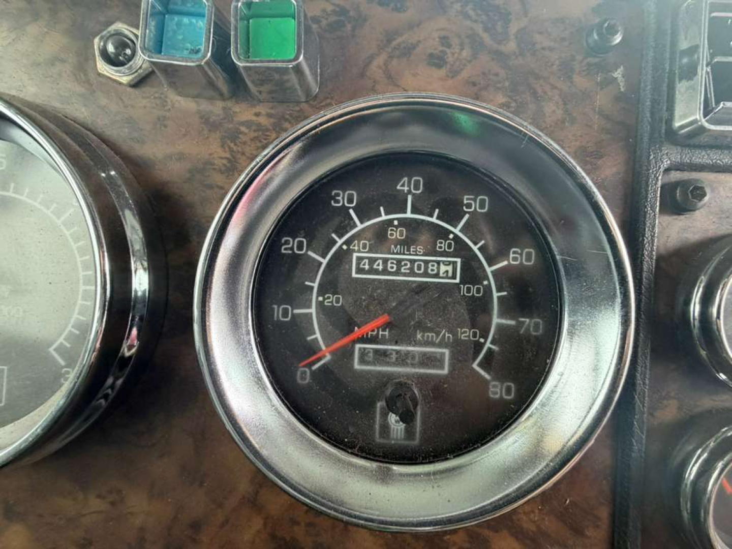 Kenworth dashboard gauge cluster showing speedometer and odometer with mileage readout and small digital display.