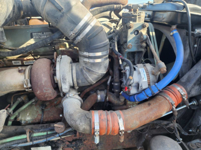 Kenworth T600 engine bay showing air intake hose, turbo, intercooler piping, hoses, and blue silicone hose clamps.