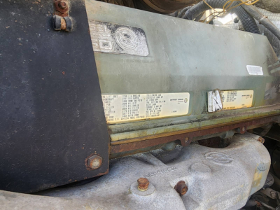Engine side view of 1994 Kenworth T600 showing data plates and badge with serial/model information.