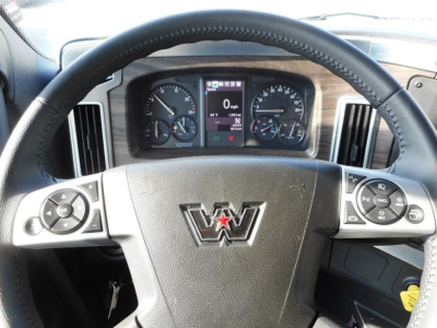 Dashboard and steering wheel of a Western Star truck showing instrument cluster and steering wheel controls.